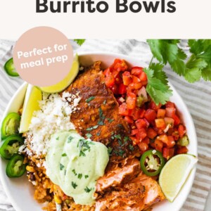 Salmon burrito bowl topped with avocado crema.