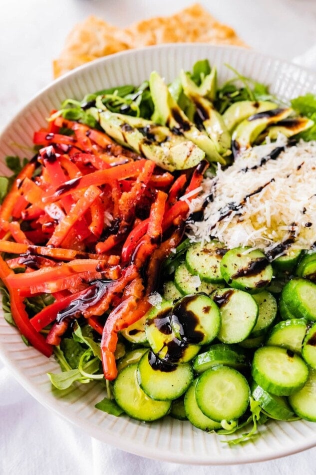 Salad drizzled with dressing.