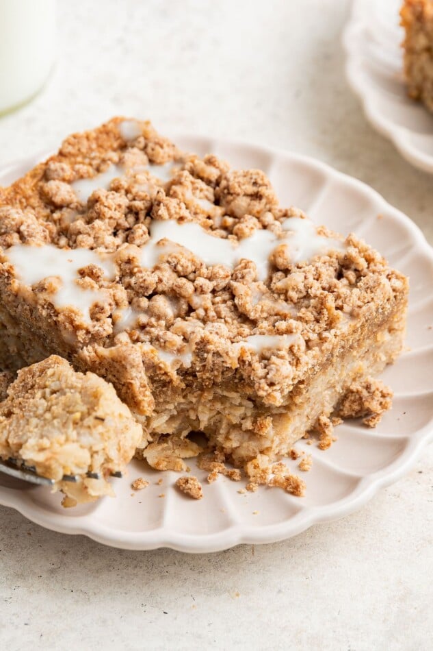 A square of coffee cake baked oatmeal with a fork.