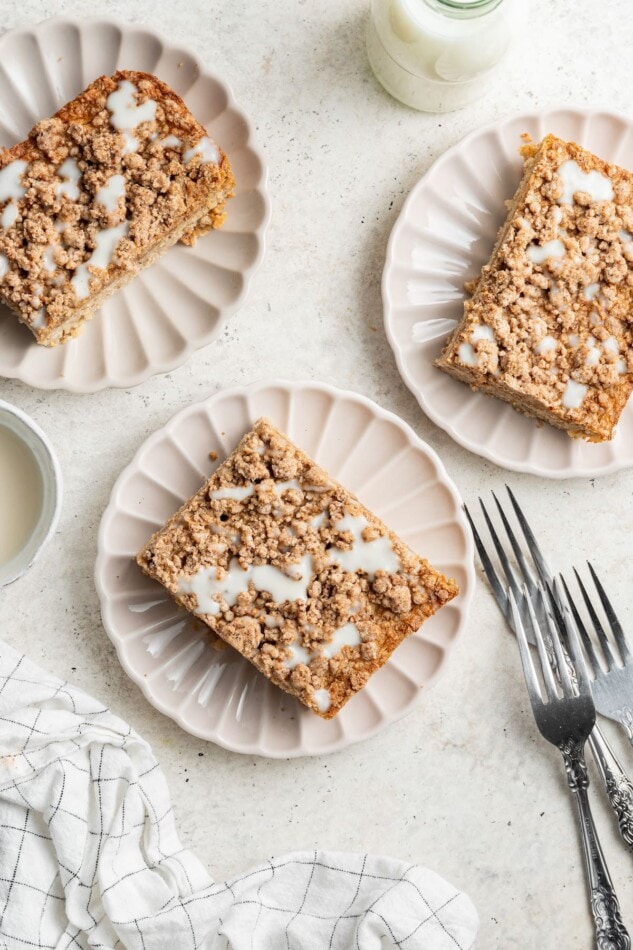 Three plates with servings of coffee cake baked oatmeal.