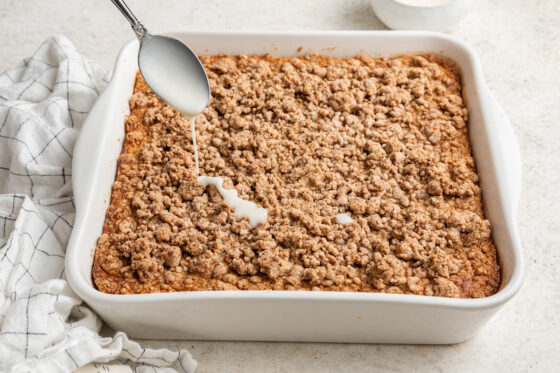 Drizzling melted coconut butter onto the baked oatmeal.