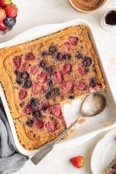 Quinoa breakfast bake in a baking dish with a serving spoon.