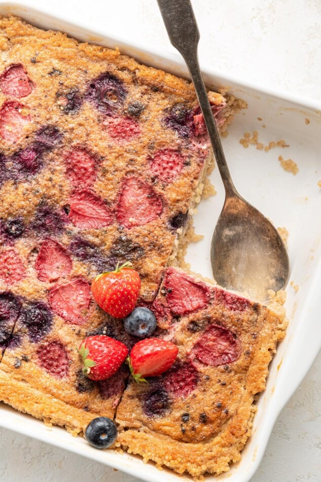 Quinoa breakfast bake in a baking dish, a serving removed.