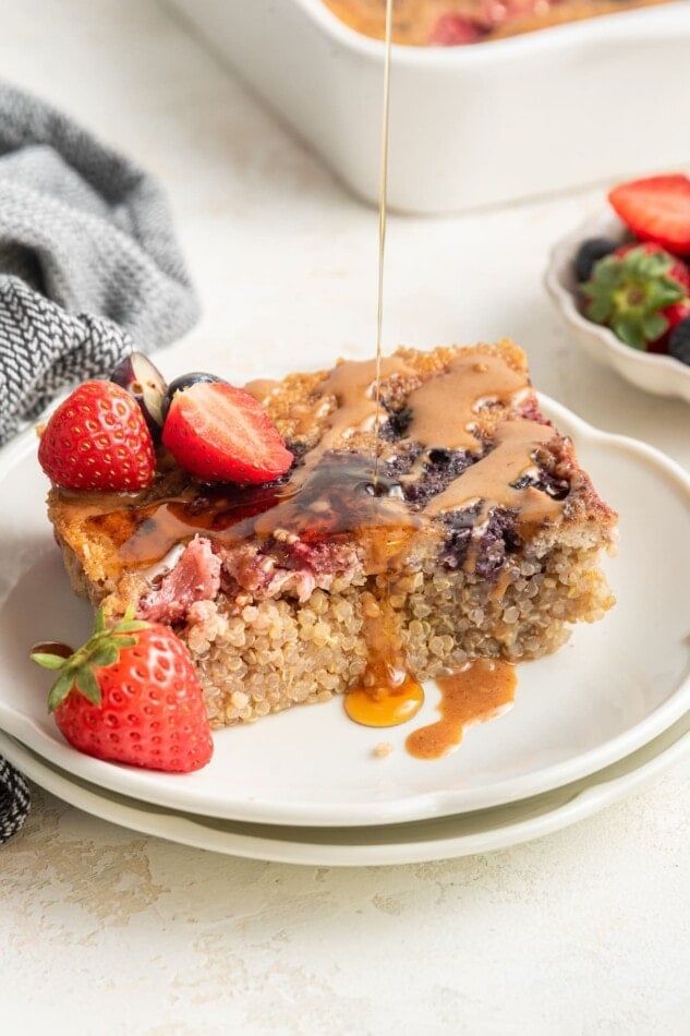 Drizzling syrup onto a serving of quinoa breakfast bake.