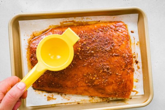 Seasoning a piece of salmon.