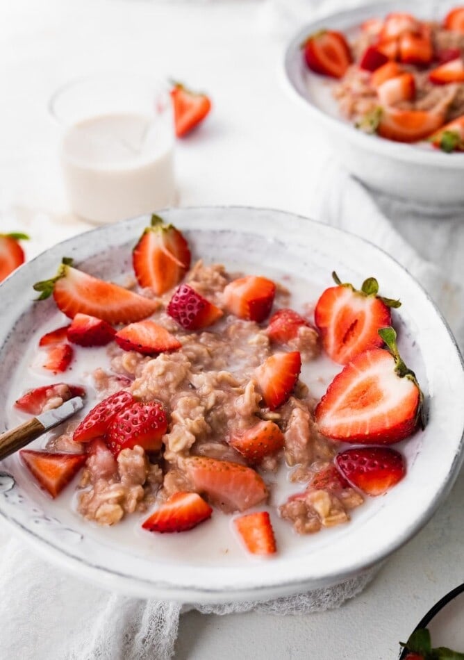 A bowl of strawberries and cream oatmeal.