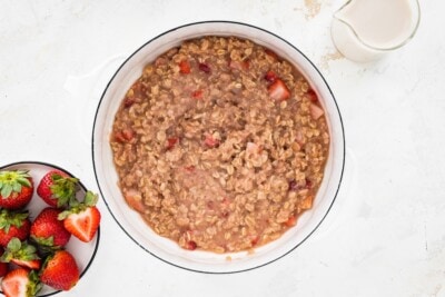 Strawberries and cream oatmeal in a sauce pan.