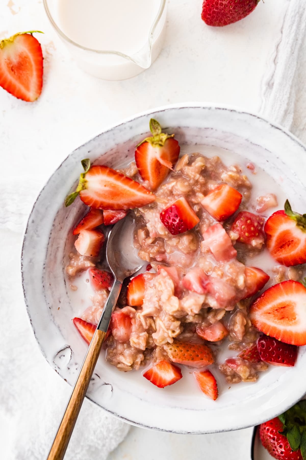 A bowl of strawberries and cream oatmeal.
