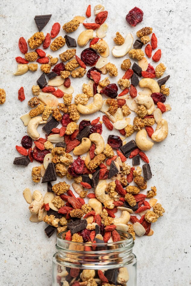Superfood trail mix spilled out on a counter top.