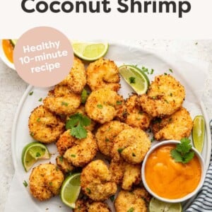 Plate of air fryer coconut shrimp served with mango chili dipping sauce.