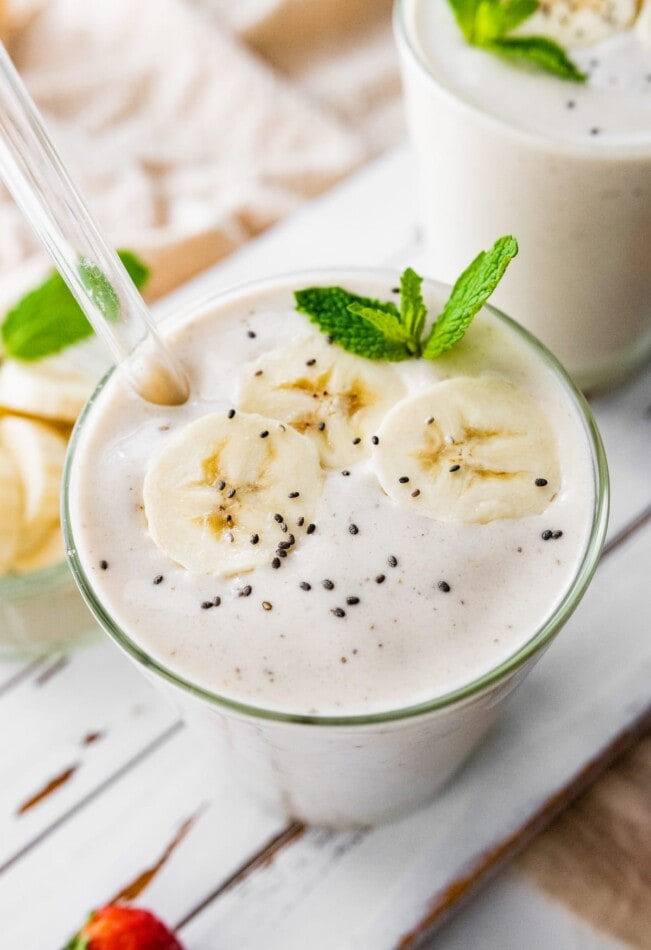 Banana protein shake with a straw.