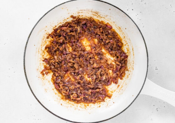 Onions, garlic and spices sautéing together in a pot.