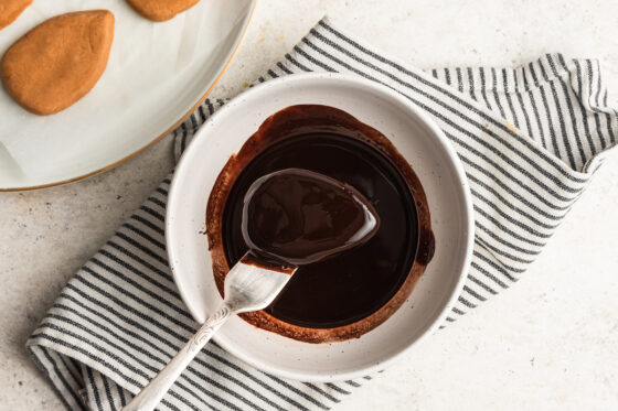 Dipping peanut butter eggs into chocolate.