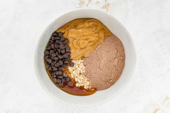 Ingredients in a bowl for chocolate peanut butter protein balls.