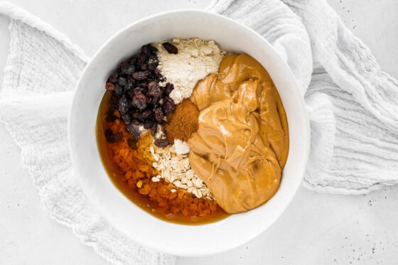 Ingredients for cinnamon raisin protein balls in a bowl.