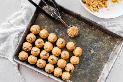 Lining up protein balls on a sheet pan.
