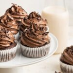 Healthy chocolate cupcakes displayed on a cake stand.