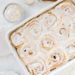 Fluffy cinnamon rolls in a baking dish.