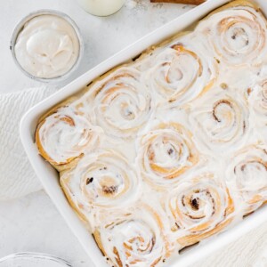 Fluffy cinnamon rolls in a baking dish.