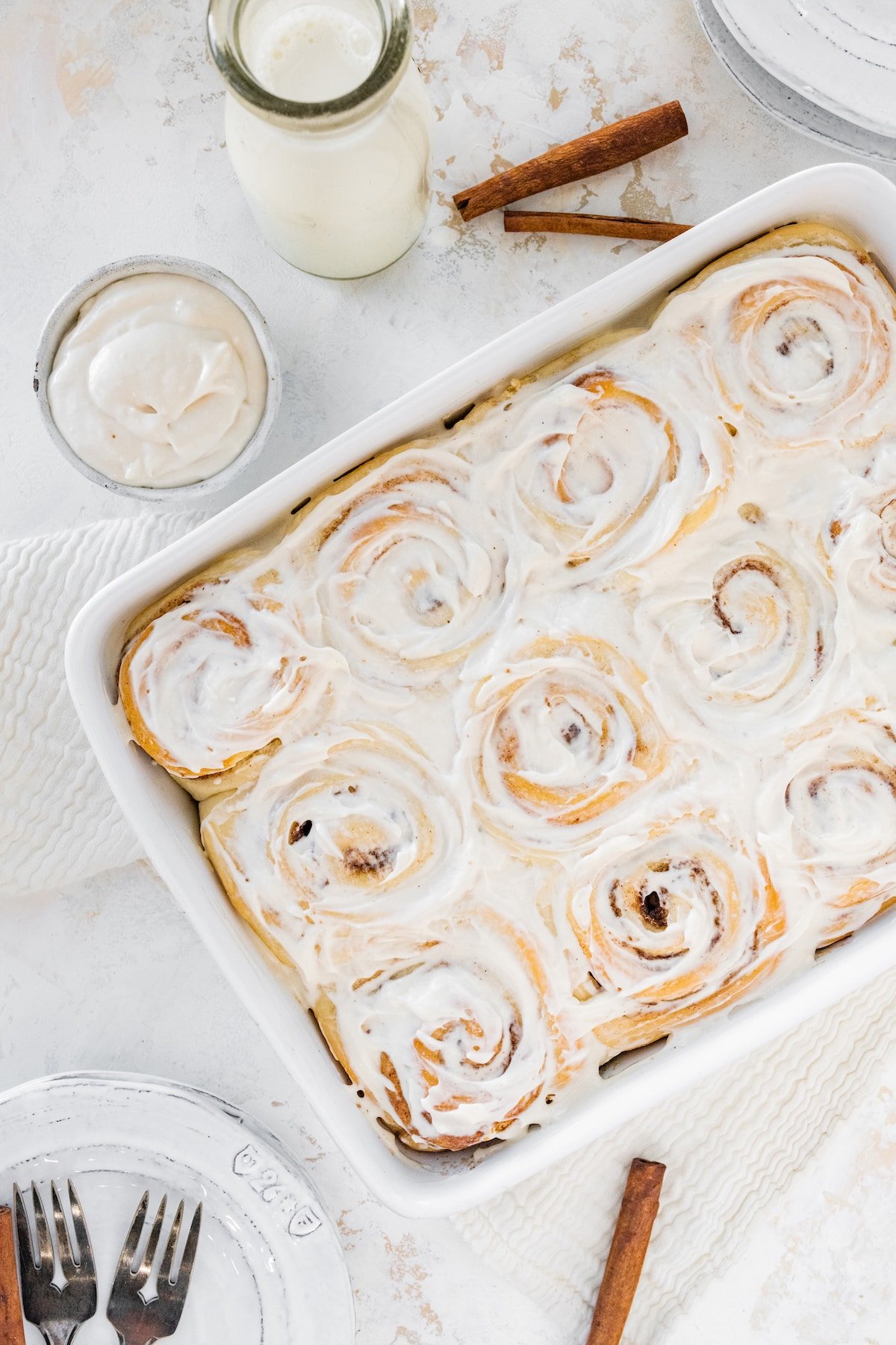 Fluffy cinnamon rolls in a baking dish.