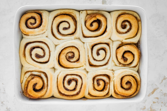Cinnamon rolls after baking in a baking dish.