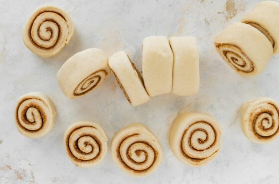 Twelve equally portioned cinnamon rolls.