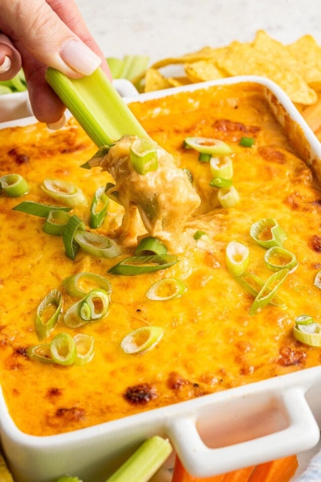 Celery dipped into healthy buffalo chicken dip.