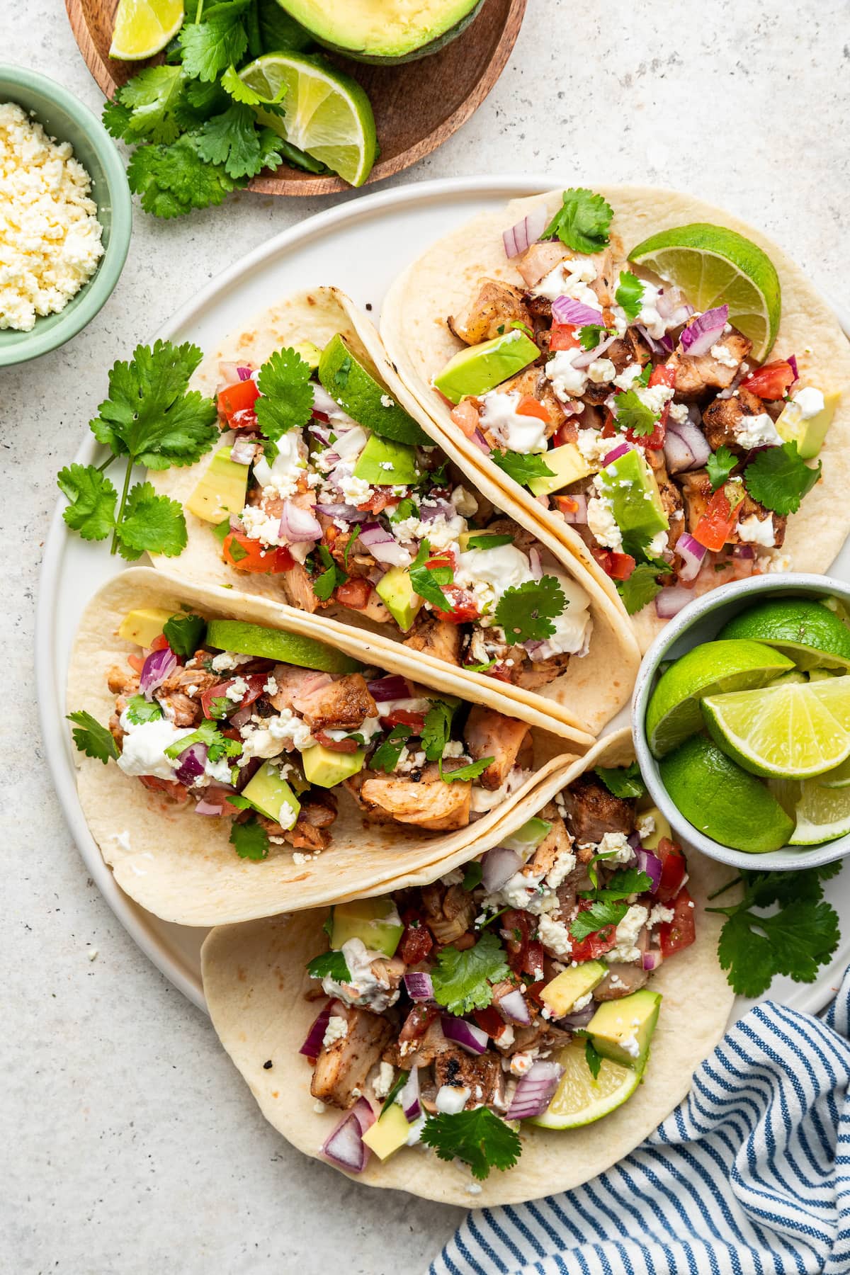 Chicken tacos arranged on a plate.