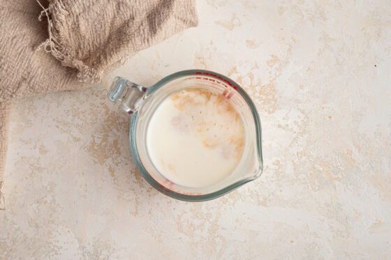 Apple cider vinegar mixed with almond milk in a measuring cup.