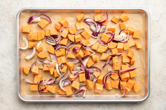 Vegetables on a sheet pan to be roasted.