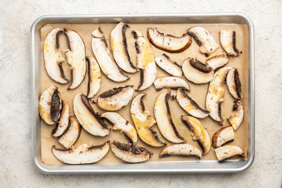 Mushrooms on a sheet pan to be roasted.