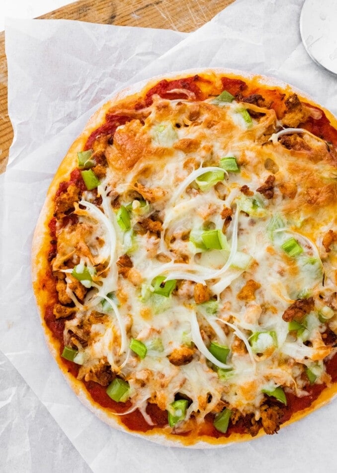 A protein pizza on parchment paper.