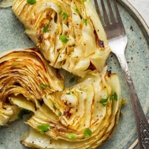 Roasted cabbage on a plate with a fork.