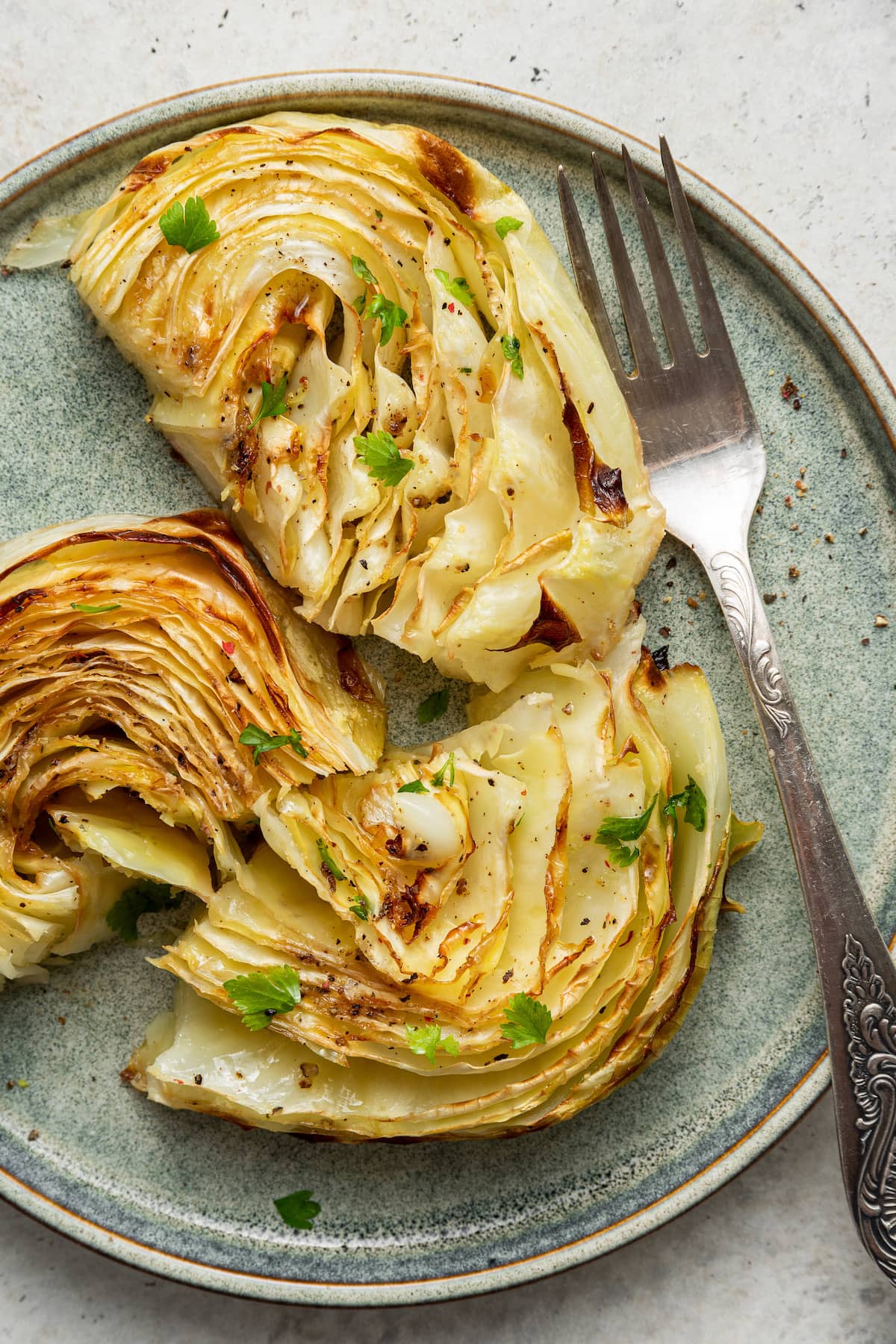 Roasted cabbage on a plate with a fork.
