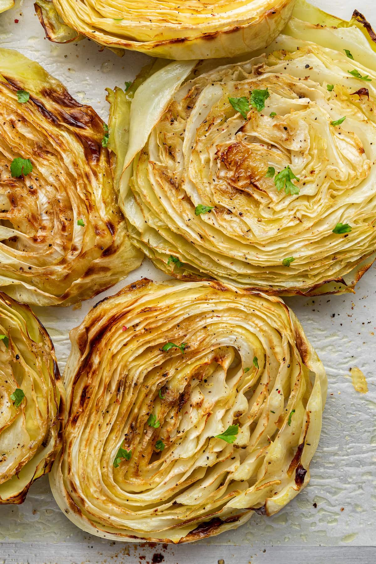 Roasted cabbage on a baking pan.