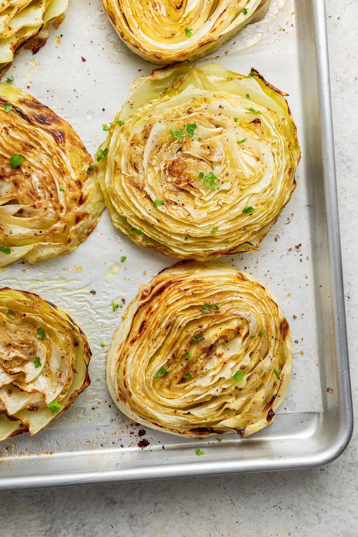 Roasted cabbage on a baking pan.