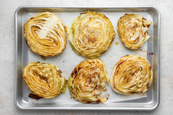 Roasted cabbage on a baking pan.