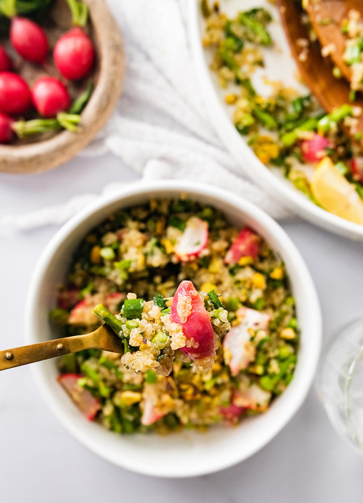 A bite of spring quinoa salad on a fork.
