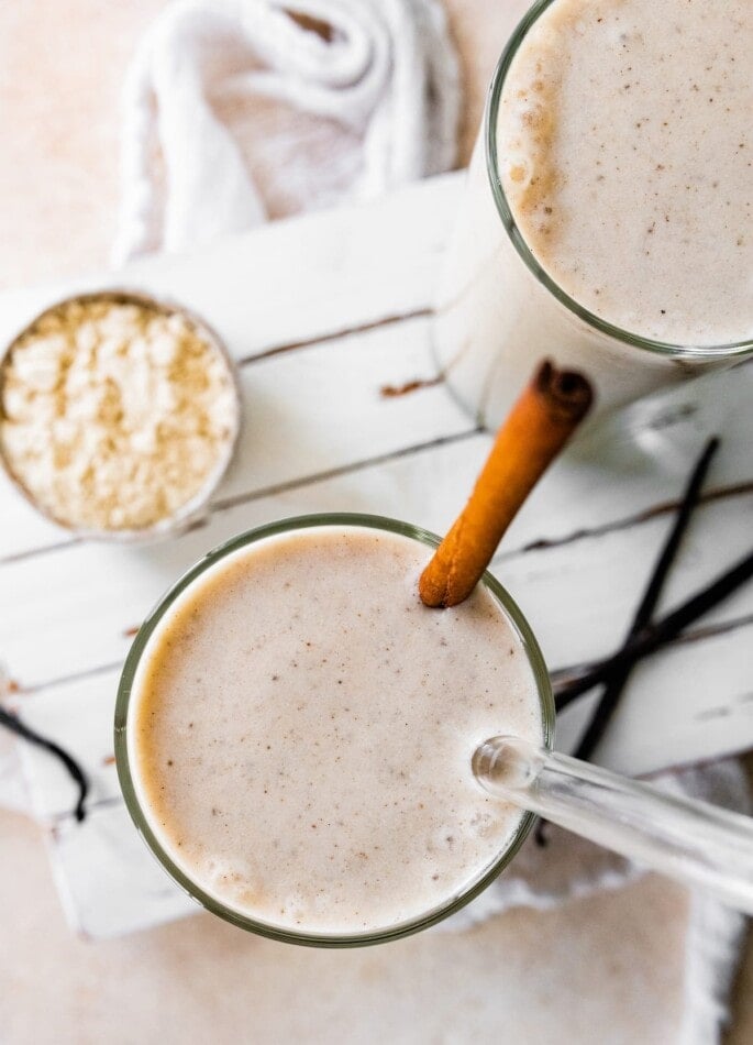 Vanilla protein shake with a cinnamon stick.