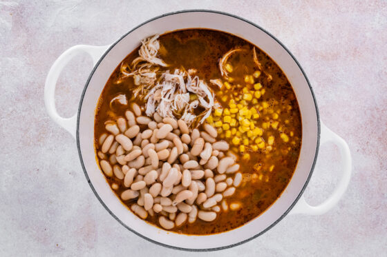 Shredded chicken, white beans and corn added to the pot.