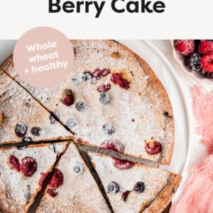 Berry cake with slices cut, and dusted with powdered sugar.