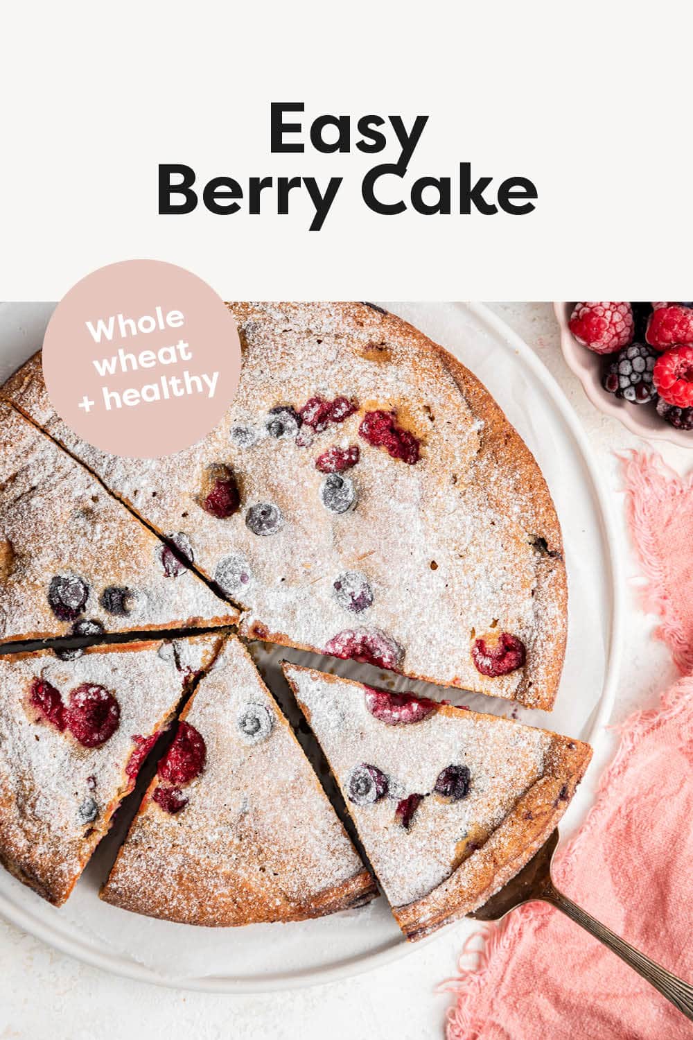 Berry cake with slices cut, and dusted with powdered sugar.