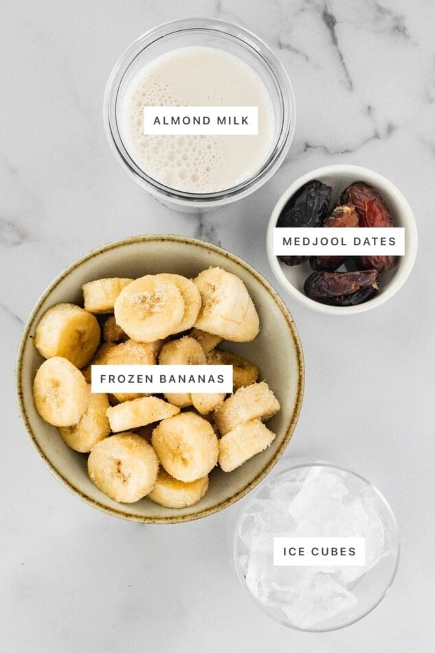 Ingredients measured out to make a Date Shake: almond milk, medjool dates, frozen banana and ice cubes.
