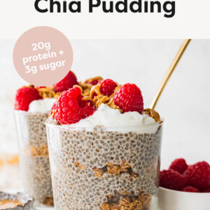 Jar of protein chia pudding layered with granola and topped with berries, nut butter and coconut whip.