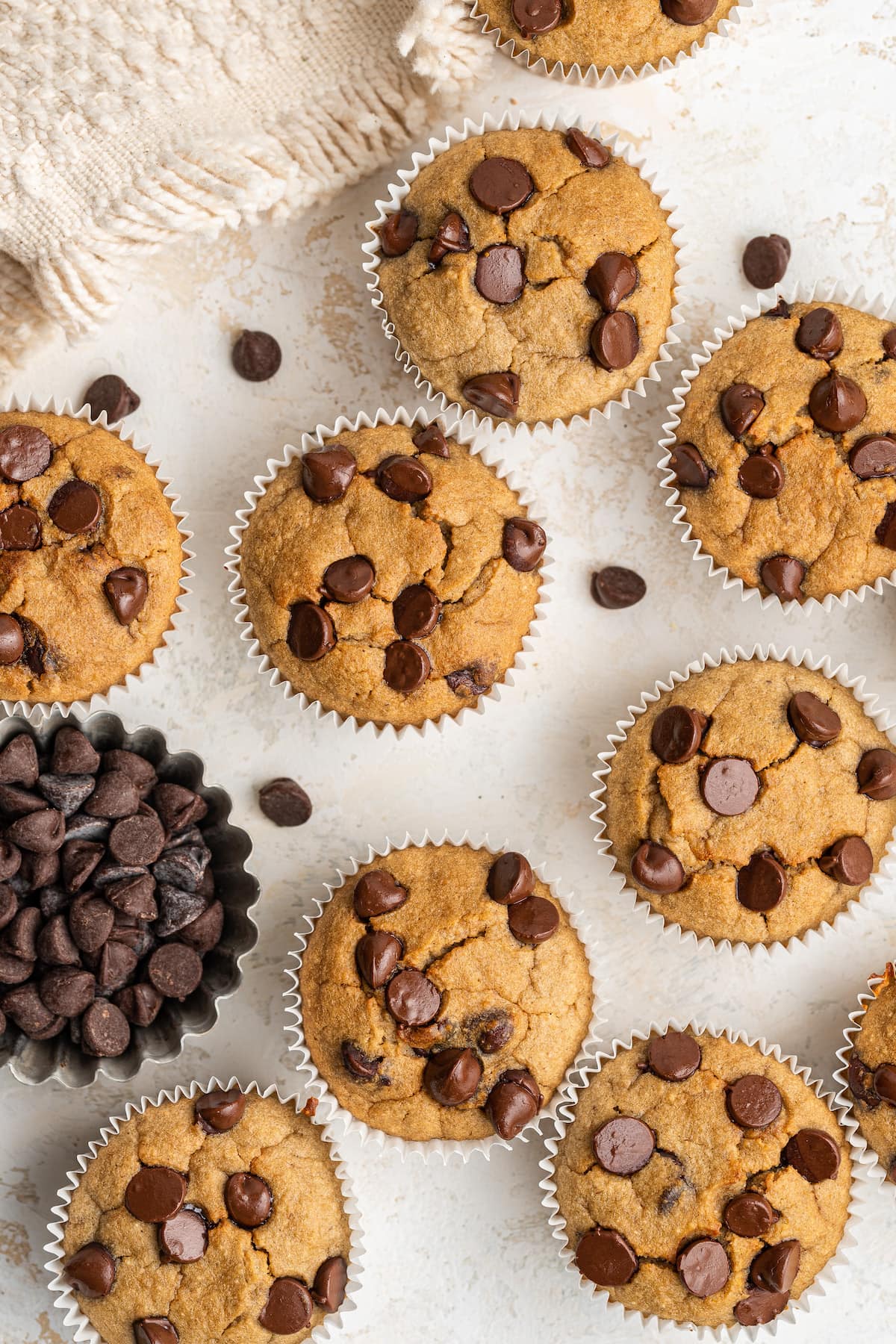 Banana blender muffins scattered around a table top.