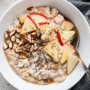 Bircher Muesli in a white bowl with a spoon.