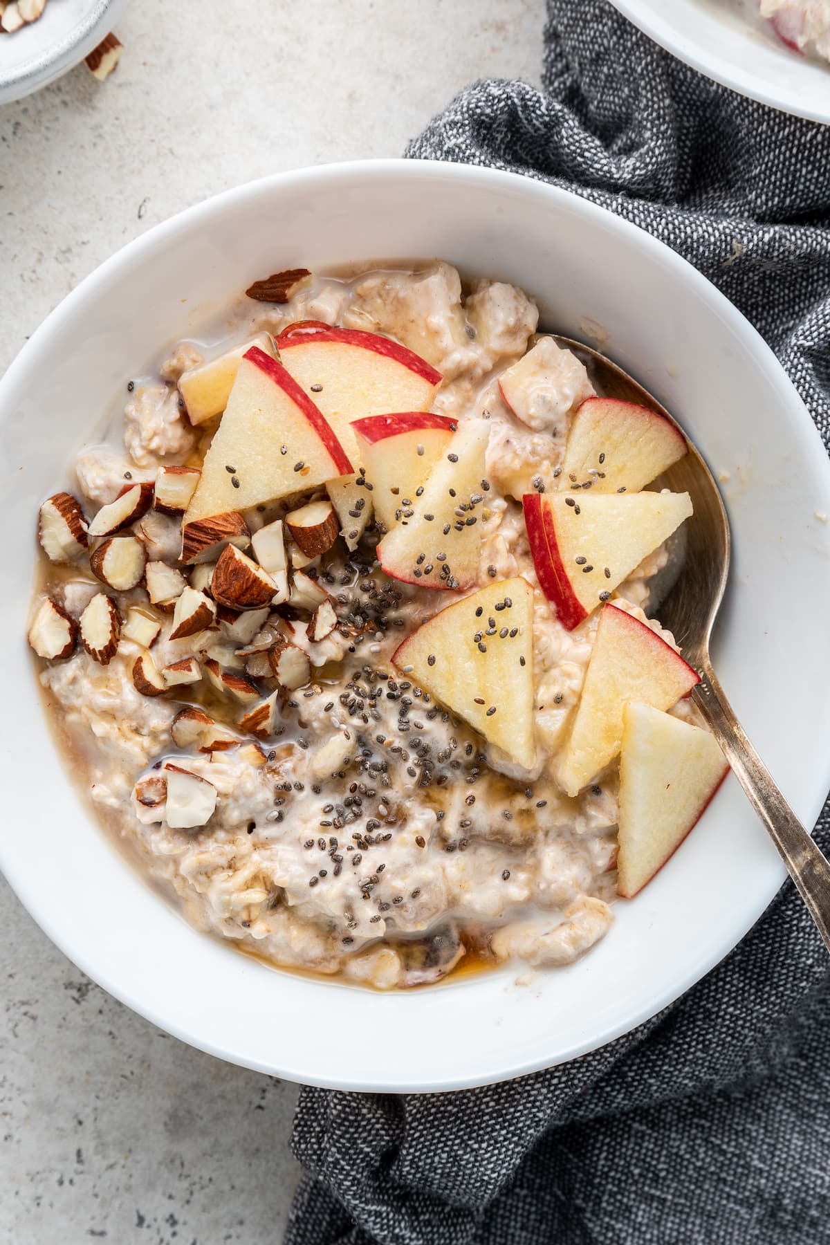 Bircher Muesli in a white bowl with a spoon.
