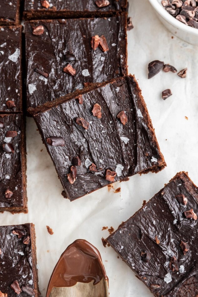 A chickpea brownie square leaning against other chickpea brownies.