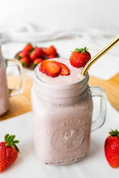 Strawberry protein shake in a mason jar.
