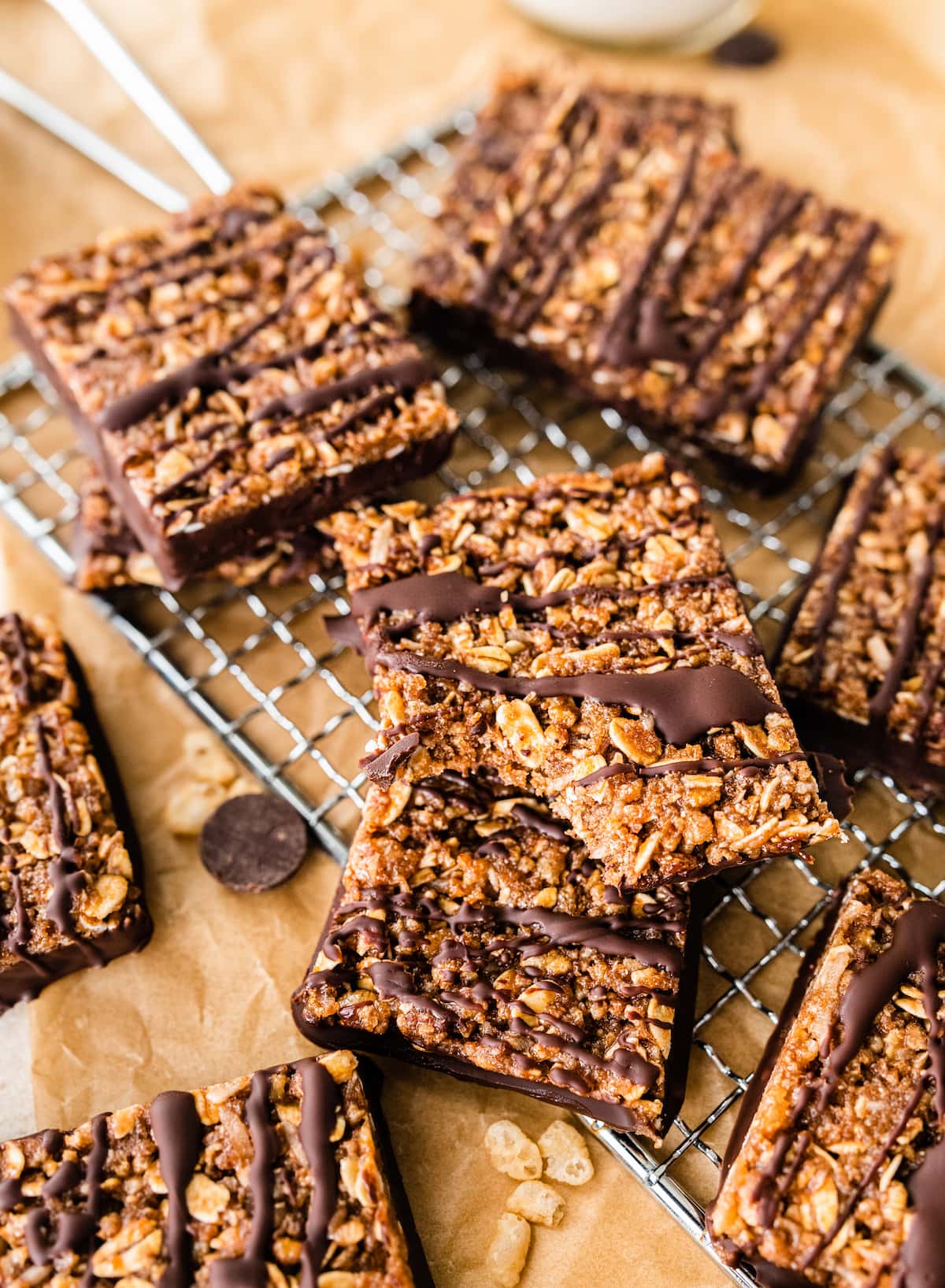 A bite taken out of a crunchy protein bar, resting with other bars.